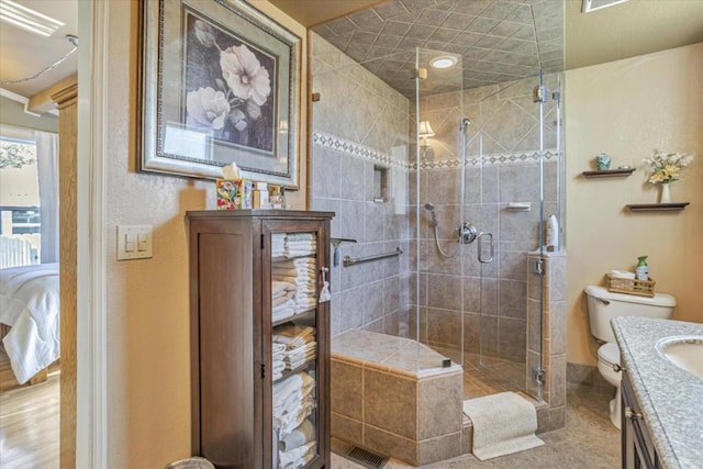 bathroom with vanity, an enclosed shower, and toilet