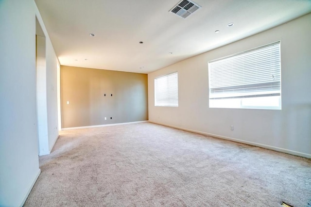 carpeted spare room with plenty of natural light