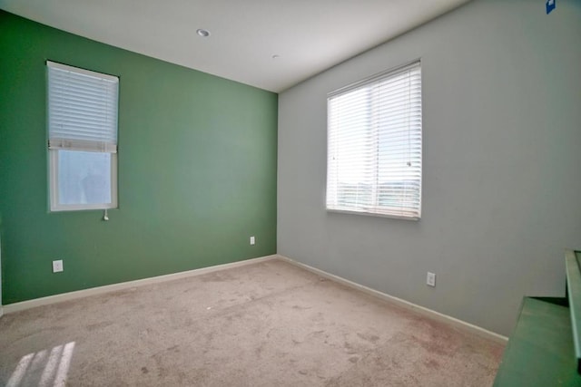 spare room featuring light colored carpet