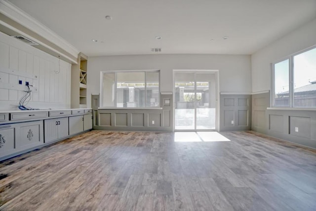 unfurnished living room featuring light wood-type flooring