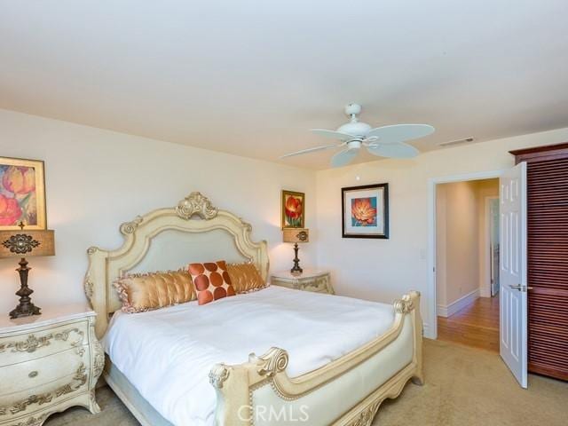 bedroom with ceiling fan and light colored carpet