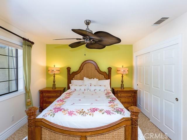 bedroom with ceiling fan and a closet