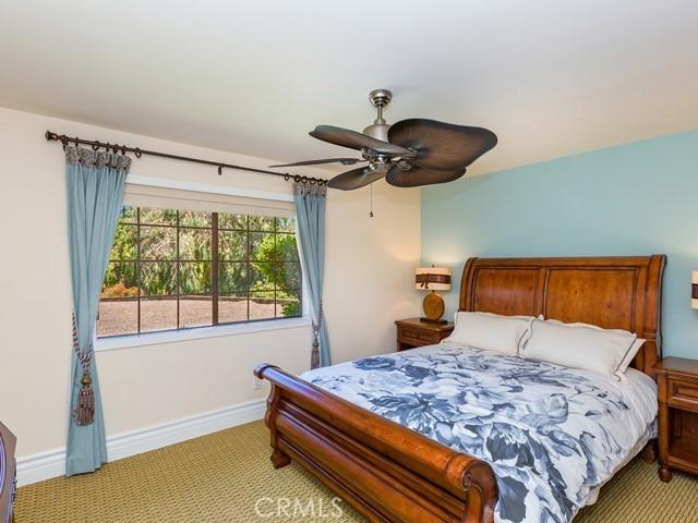 bedroom featuring ceiling fan and light colored carpet