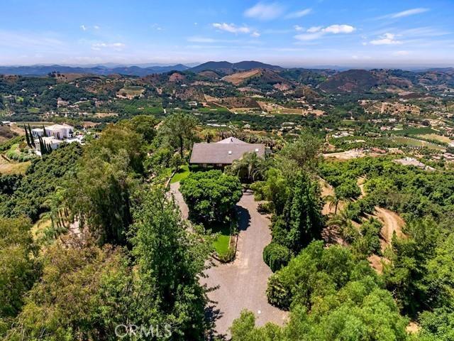 birds eye view of property with a mountain view