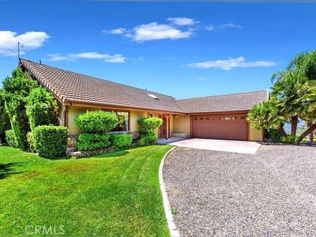 ranch-style home with a garage and a front yard