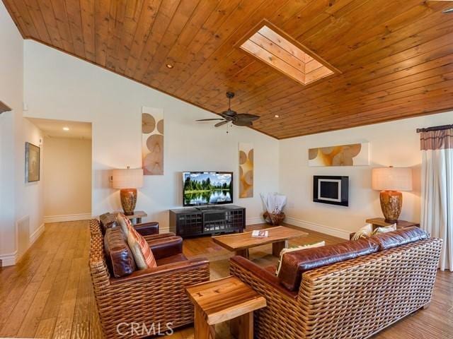 living room with light wood-type flooring, a skylight, ceiling fan, and wooden ceiling