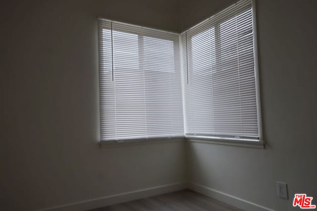 unfurnished room featuring plenty of natural light and hardwood / wood-style floors