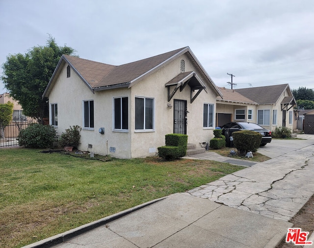 bungalow-style house with a front yard