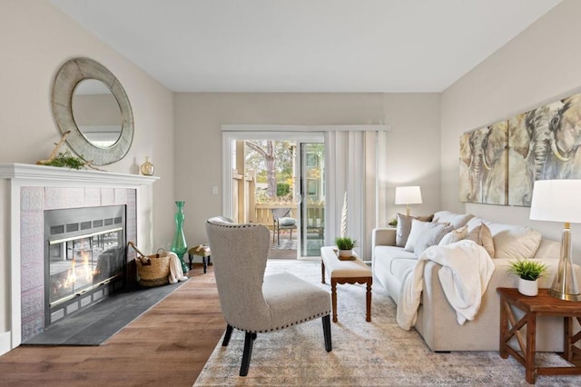 living room featuring hardwood / wood-style floors and a tile fireplace