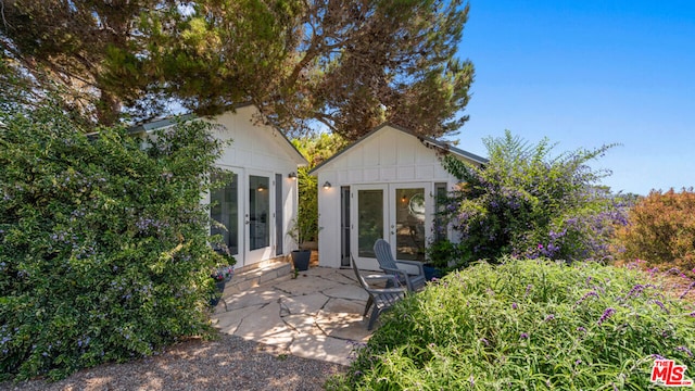 view of front of property with french doors and a patio