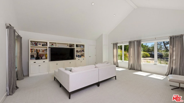 carpeted living room featuring beam ceiling and high vaulted ceiling