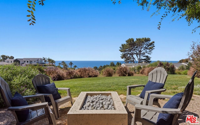 view of patio / terrace featuring a water view and a fire pit