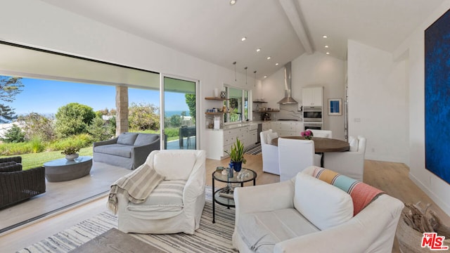 living room featuring beamed ceiling, light hardwood / wood-style floors, and high vaulted ceiling