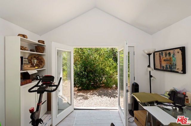 interior space with light wood-type flooring and vaulted ceiling