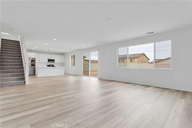 unfurnished living room featuring light wood-type flooring