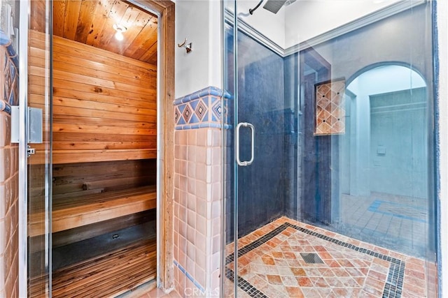 bathroom with wood walls, an enclosed shower, and wooden ceiling