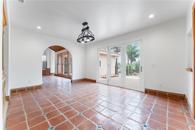 tiled spare room with french doors
