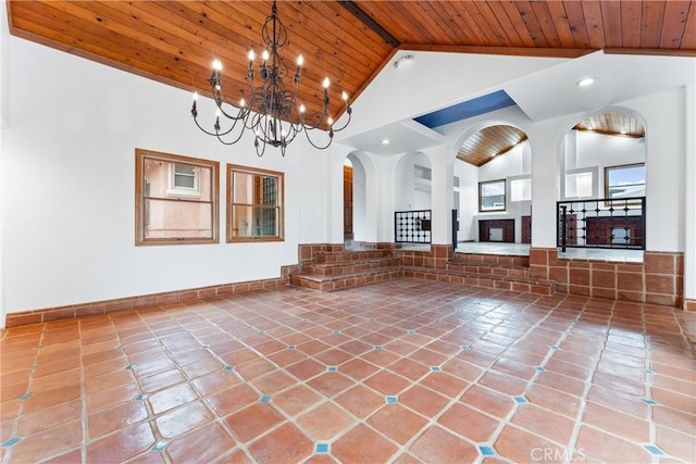unfurnished living room featuring beam ceiling, high vaulted ceiling, tile patterned floors, and wood ceiling