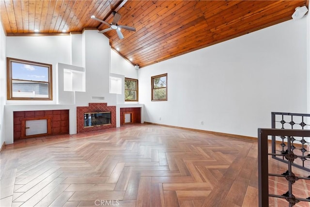 unfurnished living room with high vaulted ceiling, wood ceiling, parquet floors, and a tiled fireplace