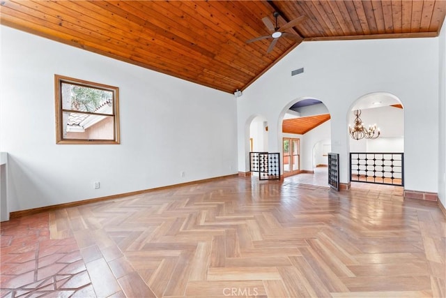 unfurnished living room featuring a wealth of natural light, light parquet floors, wood ceiling, and ceiling fan with notable chandelier