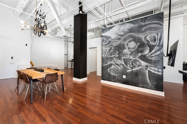 dining area with hardwood / wood-style flooring and a chandelier