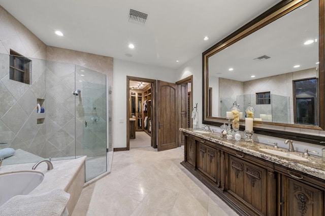 bathroom with vanity and independent shower and bath