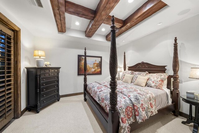 carpeted bedroom featuring beamed ceiling