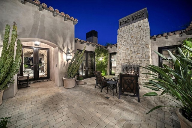 patio at night featuring french doors