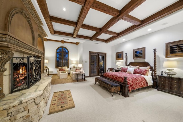 bedroom featuring french doors, beamed ceiling, light colored carpet, and coffered ceiling