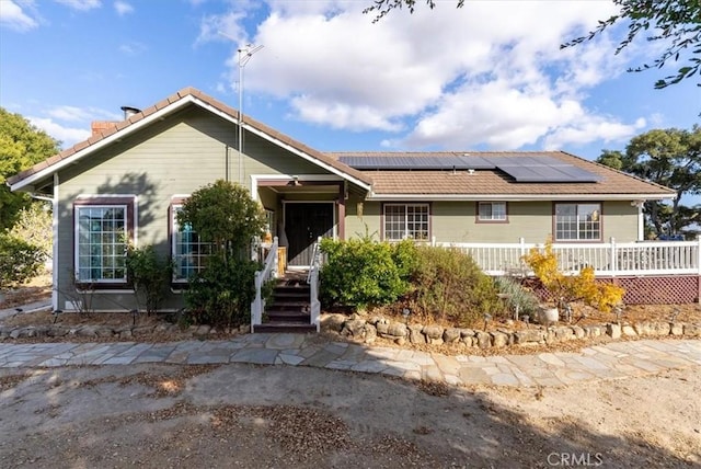 ranch-style home with solar panels