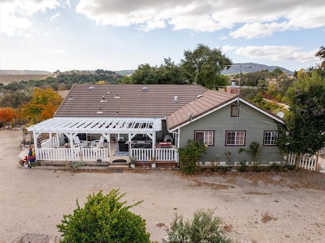 back of house with a mountain view