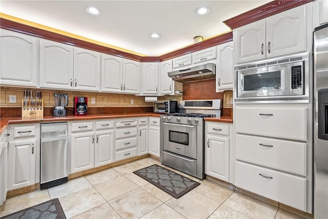 kitchen with light tile patterned floors, white cabinets, and appliances with stainless steel finishes