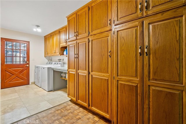 washroom with cabinets, light tile patterned floors, and washer and dryer