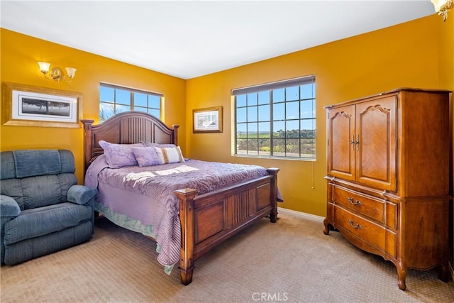 carpeted bedroom with multiple windows