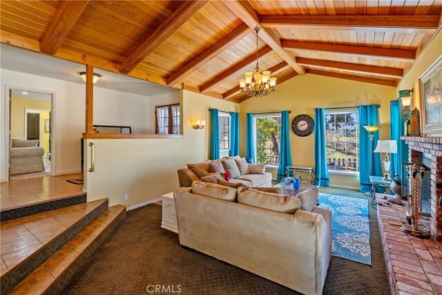 living room with wood ceiling, a fireplace, lofted ceiling with beams, and a chandelier