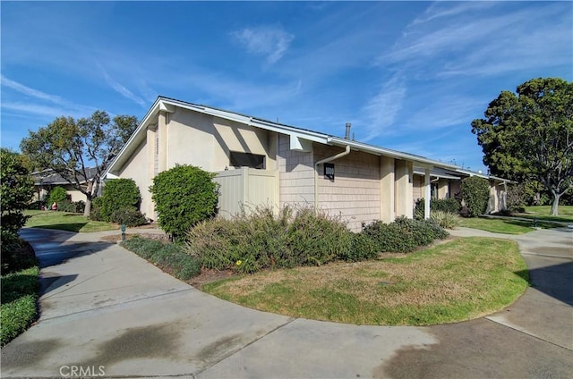 view of property exterior featuring a lawn