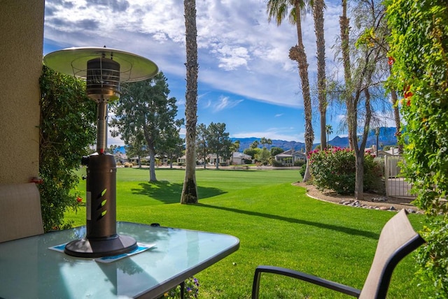 surrounding community featuring a mountain view and a yard