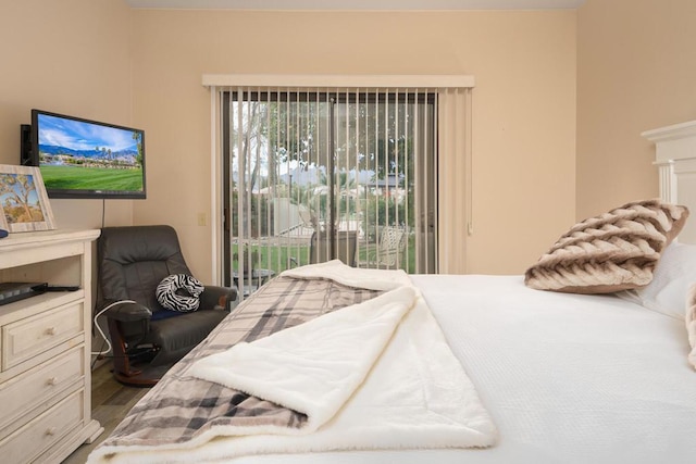 bedroom featuring access to exterior and hardwood / wood-style floors