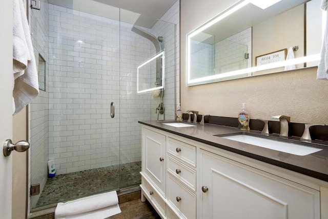 bathroom featuring vanity and an enclosed shower