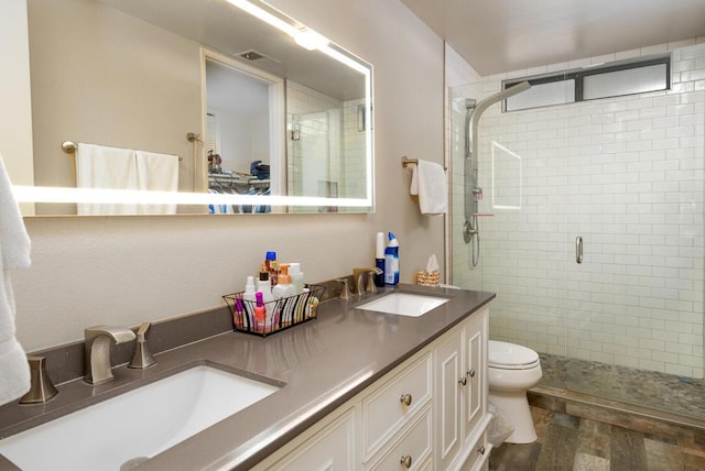 bathroom featuring vanity, toilet, and an enclosed shower