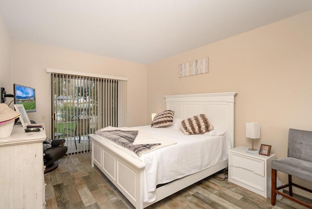 bedroom with access to exterior and dark hardwood / wood-style flooring