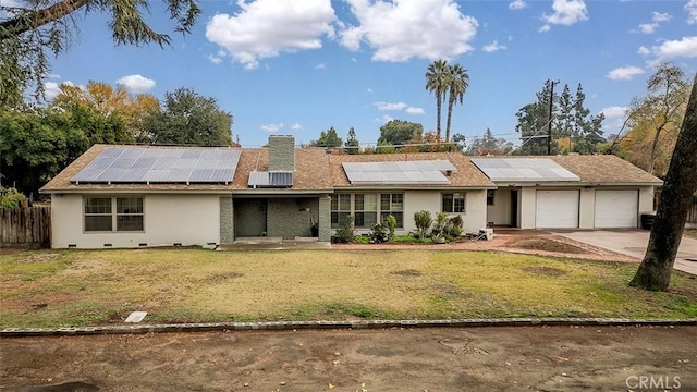 view of front of property featuring solar panels, a garage, and a front lawn