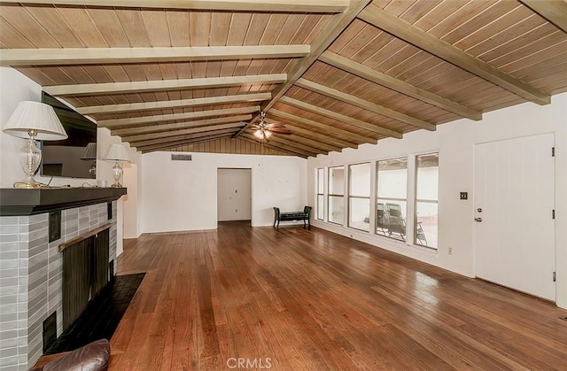 unfurnished living room featuring a brick fireplace, ceiling fan, vaulted ceiling with beams, and hardwood / wood-style flooring