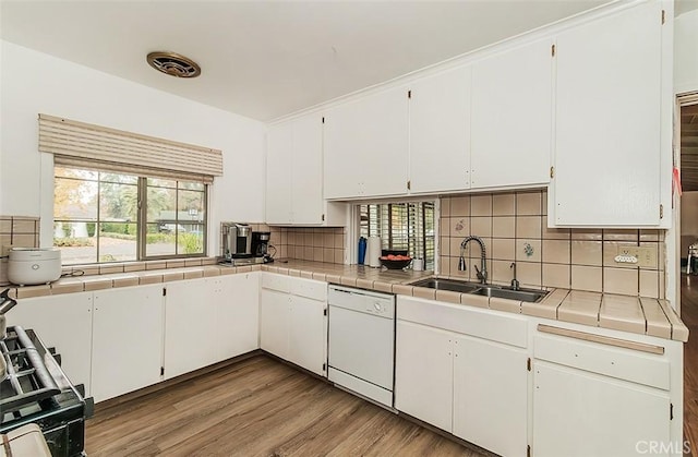 kitchen featuring tile countertops, white cabinetry, and dishwasher