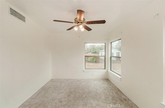 carpeted empty room featuring ceiling fan