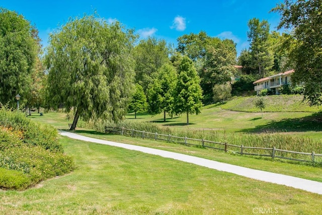 view of property's community featuring a lawn and a rural view