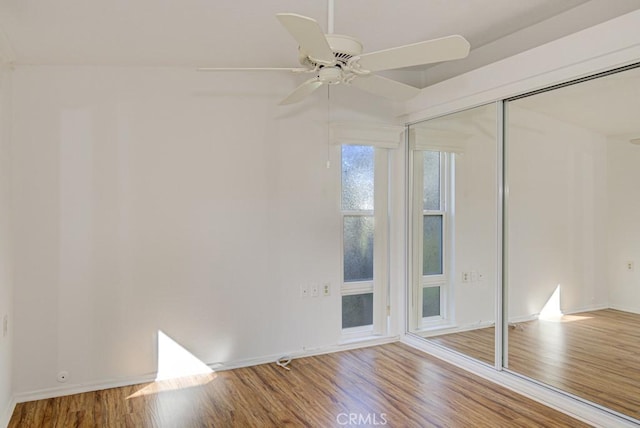 spare room featuring hardwood / wood-style floors, ceiling fan, and lofted ceiling