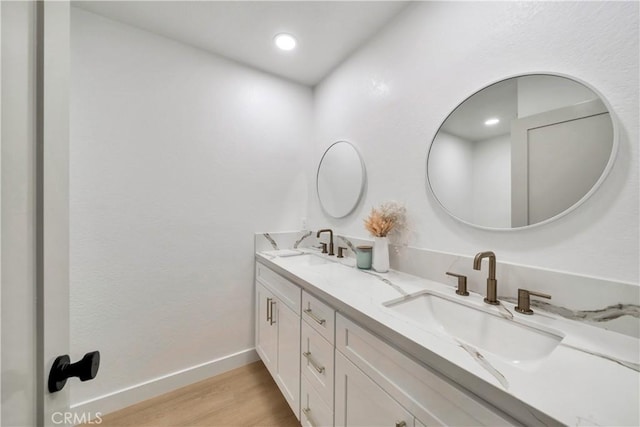 bathroom with hardwood / wood-style floors and vanity