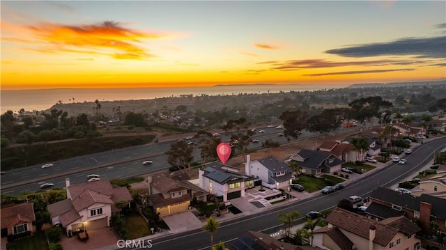 aerial view at dusk with a water view