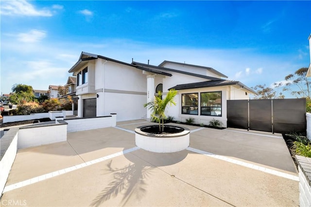 view of front of home featuring a garage and a fire pit